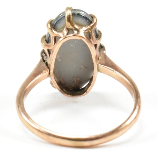 214 - A 9ct gold opal triplet ring. The ring set with an oval opal claw mounted opal triplet to tapering b... 