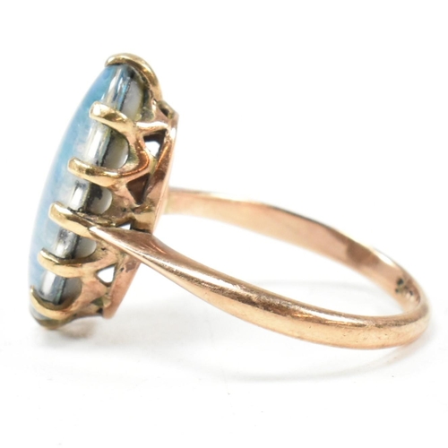 214 - A 9ct gold opal triplet ring. The ring set with an oval opal claw mounted opal triplet to tapering b... 