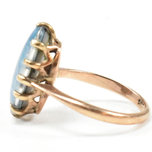 214 - A 9ct gold opal triplet ring. The ring set with an oval opal claw mounted opal triplet to tapering b... 