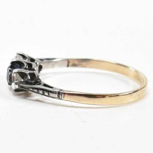 215 - A 9ct gold and silver spinel set three stone ring. The ring having an emerald cut spinet to centre w... 