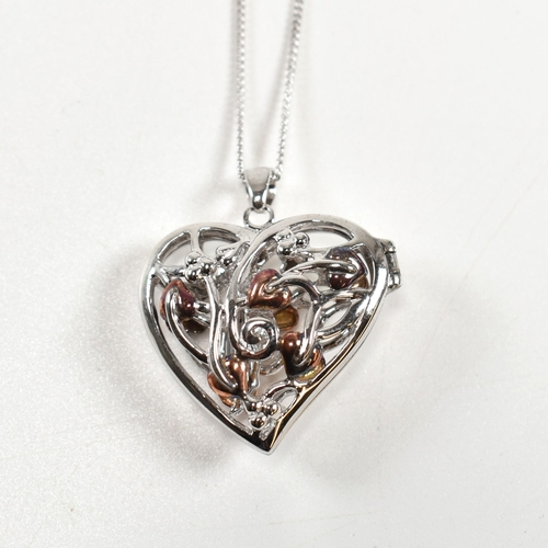 222 - A hallmarked silver Clogau heart locket pendant necklace with fairy. The silver Clogau curb link cha... 