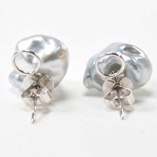 225 - A pair of baroque pearl and 18ct white gold stud earrings. The earrings having baroque pearls surmou... 