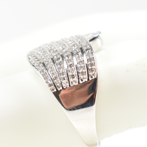 226 - A hallmarked 9ct white gold and diamond pave ring. The ring set with eight rows of pave set round cu... 