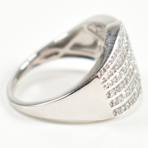 226 - A hallmarked 9ct white gold and diamond pave ring. The ring set with eight rows of pave set round cu... 