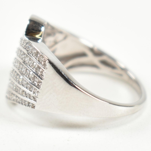 226 - A hallmarked 9ct white gold and diamond pave ring. The ring set with eight rows of pave set round cu... 