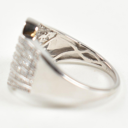 226 - A hallmarked 9ct white gold and diamond pave ring. The ring set with eight rows of pave set round cu... 