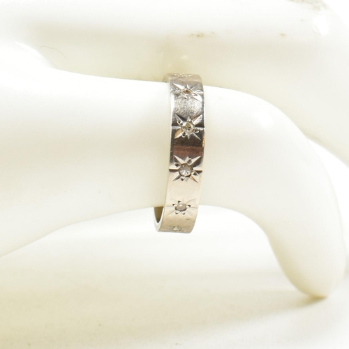 228 - Hallmarked 18ct gold and diamond eternity ring. The white gold ring set with star set single cut dia... 