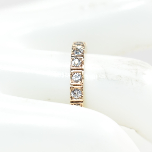 229 - A 9ct rose gold and diamond eternity ring. The ring set all around with round cut diamonds. Marked 9... 