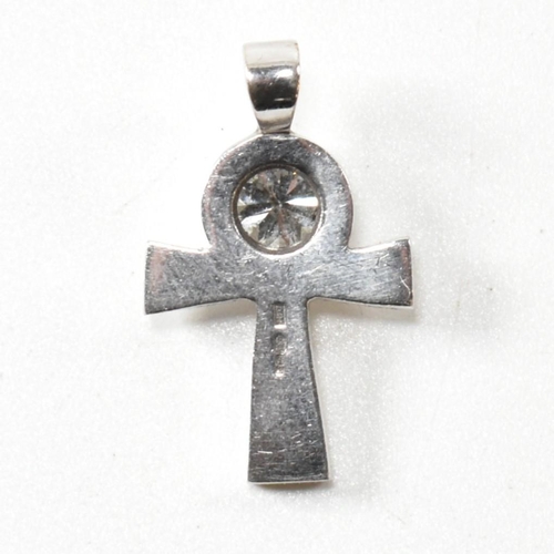 23 - A hallmarked white gold and diamond cross necklace pendant. The cross necklace pendant set with a si... 