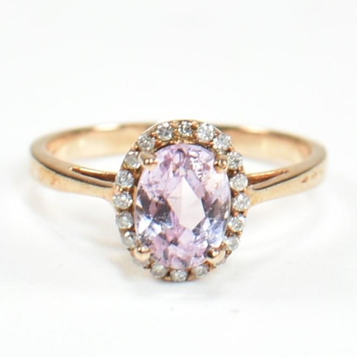 231 - A hallmarked 9ct gold kunzite and diamond cluster ring. The ring set with a four claw set oval cut k... 