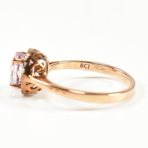 231 - A hallmarked 9ct gold kunzite and diamond cluster ring. The ring set with a four claw set oval cut k... 