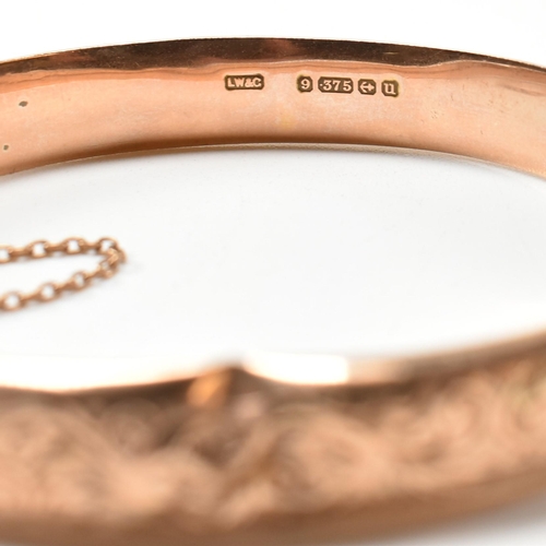 232 - An early 20th century hallmarked 9ct rose gold engraved hinged bangle. The 9ct rose gold bangle havi... 