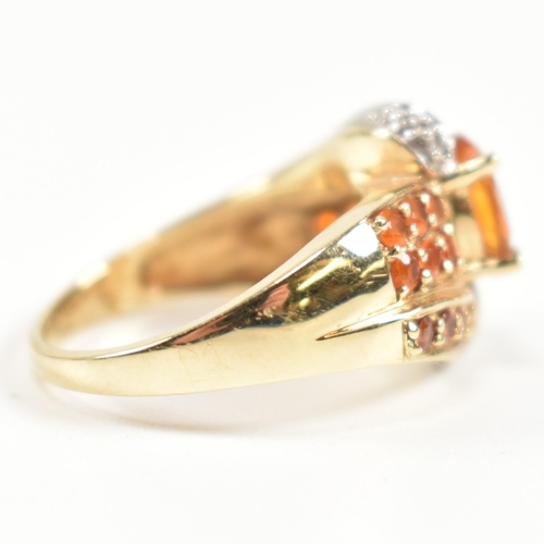 234 - A hallmarked diamond and gem set crossover ring. The ring having a central oval cut citrine set in a... 