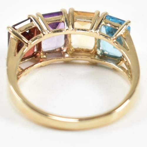 235 - A hallmarked 9ct gold, garnet, amethyst, citrine and topaz ring. The ring set with a row of emerald ... 