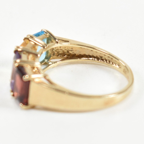 235 - A hallmarked 9ct gold, garnet, amethyst, citrine and topaz ring. The ring set with a row of emerald ... 