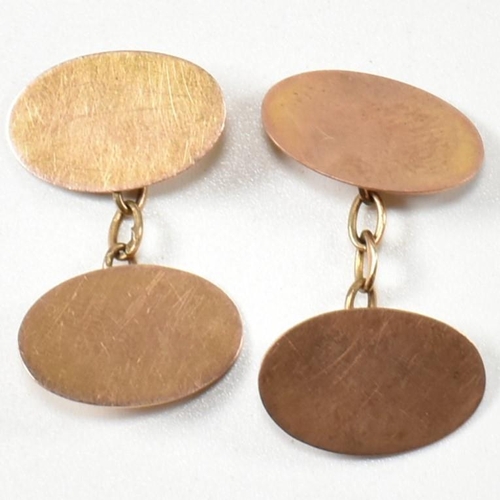 240 - A pair of 1930S hallmarked 9ct gold cufflinks. The cufflinks formed with two oval heads united by ch... 