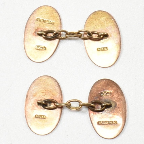 240 - A pair of 1930S hallmarked 9ct gold cufflinks. The cufflinks formed with two oval heads united by ch... 