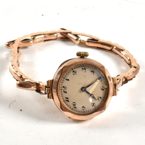 243 - A 9ct gold London hallmarked ladies dress cocktail watch. Silvered dial with Arabic numbers. Set to ... 