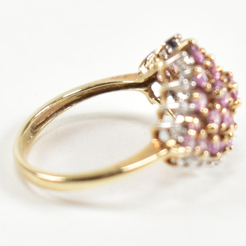 244 - A hallmarked 9ct gold, pink sapphire and diamond cluster ring. The ring set with a cluster of gradua... 