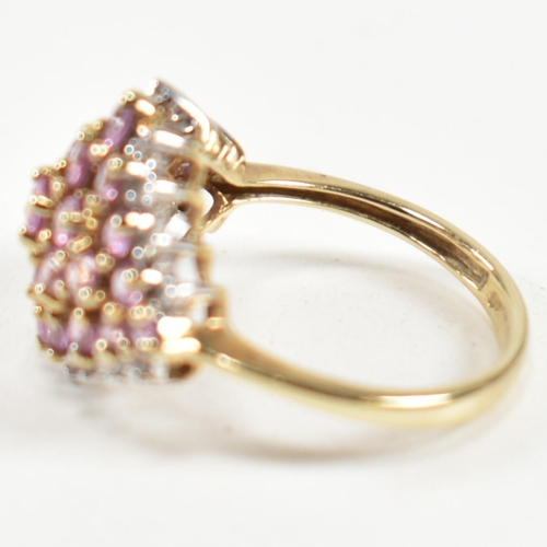 244 - A hallmarked 9ct gold, pink sapphire and diamond cluster ring. The ring set with a cluster of gradua... 