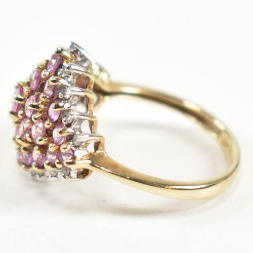 244 - A hallmarked 9ct gold, pink sapphire and diamond cluster ring. The ring set with a cluster of gradua... 