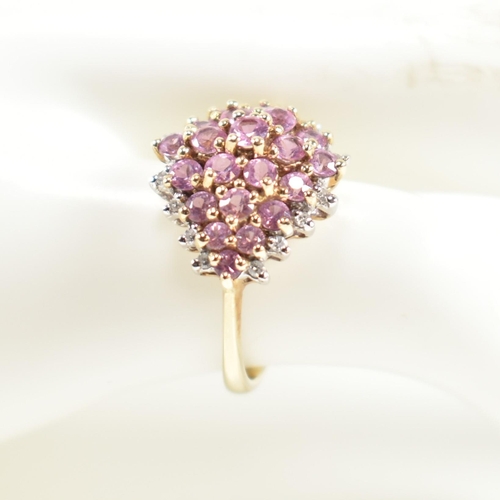 244 - A hallmarked 9ct gold, pink sapphire and diamond cluster ring. The ring set with a cluster of gradua... 