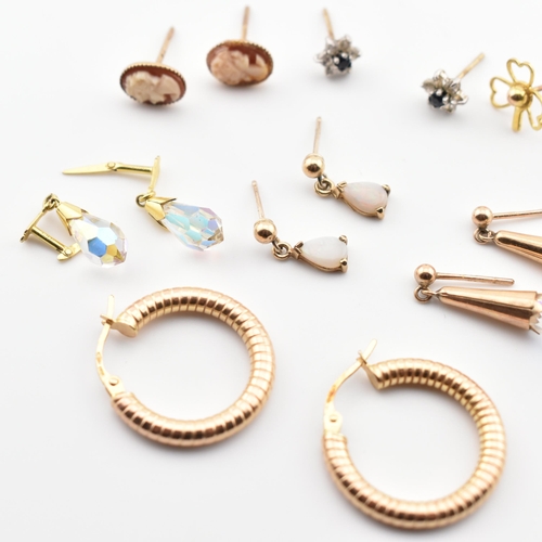 246 - A collection of 9ct gold and gem set earrings. The lot to include a pair of 9ct gold hoop earrings, ... 