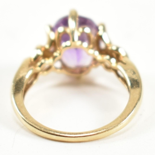 248 - A hallmarked 9ct gold and amethyst ring. The ring having a central six claw set oval cut amethyst to... 