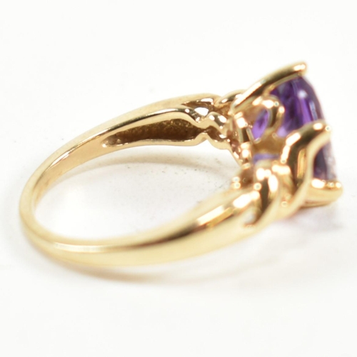 248 - A hallmarked 9ct gold and amethyst ring. The ring having a central six claw set oval cut amethyst to... 