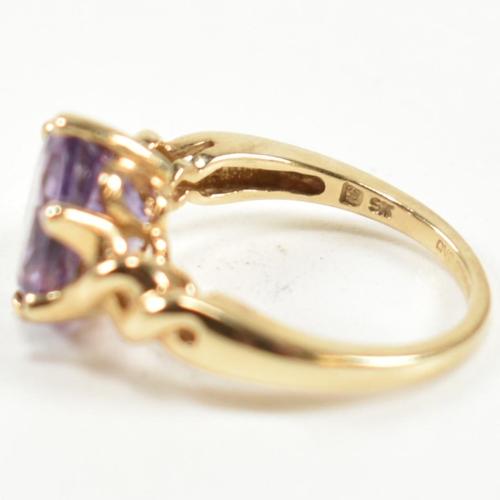 248 - A hallmarked 9ct gold and amethyst ring. The ring having a central six claw set oval cut amethyst to... 