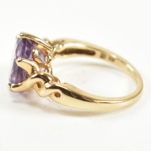 248 - A hallmarked 9ct gold and amethyst ring. The ring having a central six claw set oval cut amethyst to... 