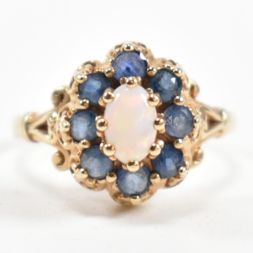 252 - A hallmarked 9ct gold, sapphire and opal cluster ring. The ring set with a central oval opal cabocho... 