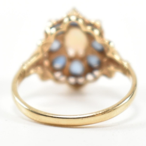 252 - A hallmarked 9ct gold, sapphire and opal cluster ring. The ring set with a central oval opal cabocho... 