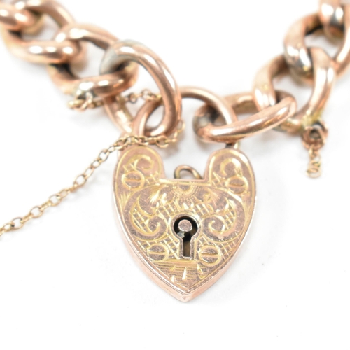 256 - A 19th century rose metal curb link chain bracelet with a 9ct gold heart padlock clasp. The curb lin... 