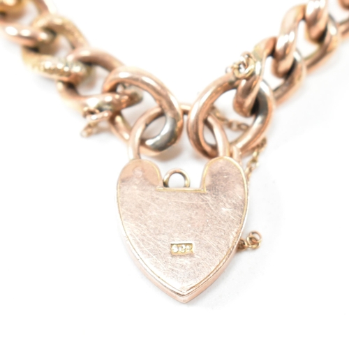 256 - A 19th century rose metal curb link chain bracelet with a 9ct gold heart padlock clasp. The curb lin... 