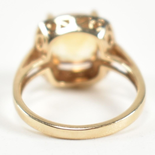 257 - A hallmarked 9ct gold, citrine and diamond ring. The ring set with a central cushion cut citrine sur... 