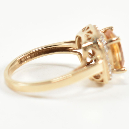 257 - A hallmarked 9ct gold, citrine and diamond ring. The ring set with a central cushion cut citrine sur... 