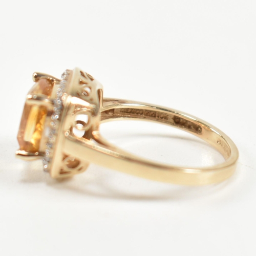 257 - A hallmarked 9ct gold, citrine and diamond ring. The ring set with a central cushion cut citrine sur... 