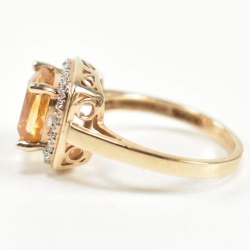 257 - A hallmarked 9ct gold, citrine and diamond ring. The ring set with a central cushion cut citrine sur... 