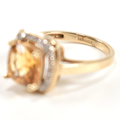 257 - A hallmarked 9ct gold, citrine and diamond ring. The ring set with a central cushion cut citrine sur... 