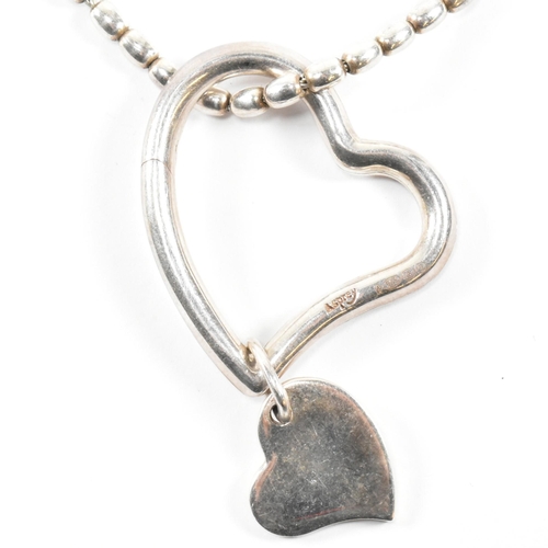 26 - An Asprey hallmarked silver heart pendant necklace. The Asprey necklace having a solid silver heart ... 