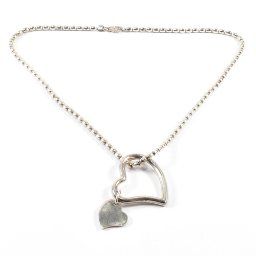 26 - An Asprey hallmarked silver heart pendant necklace. The Asprey necklace having a solid silver heart ... 