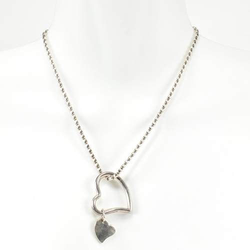 26 - An Asprey hallmarked silver heart pendant necklace. The Asprey necklace having a solid silver heart ... 