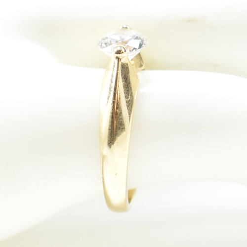 263 - A hallmarked 14ct gold and CZ solitaire ring. The ring set with a single round cut CZ with pinched s... 