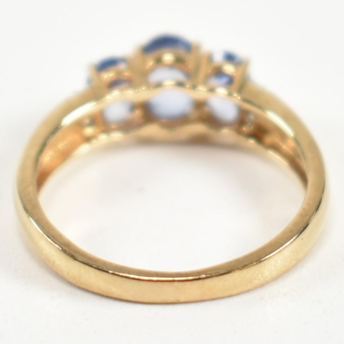 266 - A hallmarked 9ct gold, sapphire and diamond trilogy ring. The ring set with three graduating oval cu... 