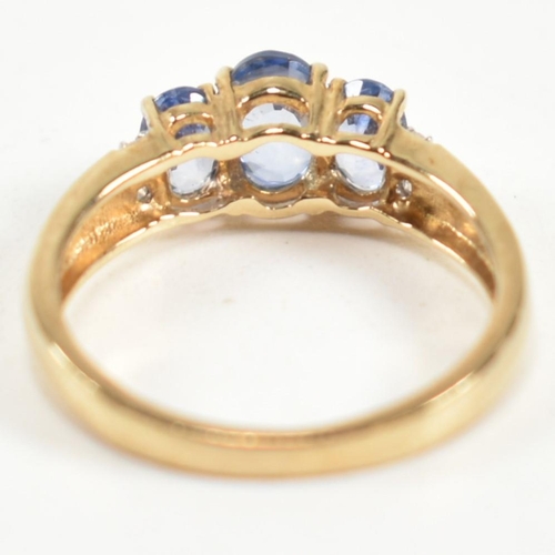 266 - A hallmarked 9ct gold, sapphire and diamond trilogy ring. The ring set with three graduating oval cu... 