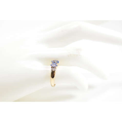 266 - A hallmarked 9ct gold, sapphire and diamond trilogy ring. The ring set with three graduating oval cu... 