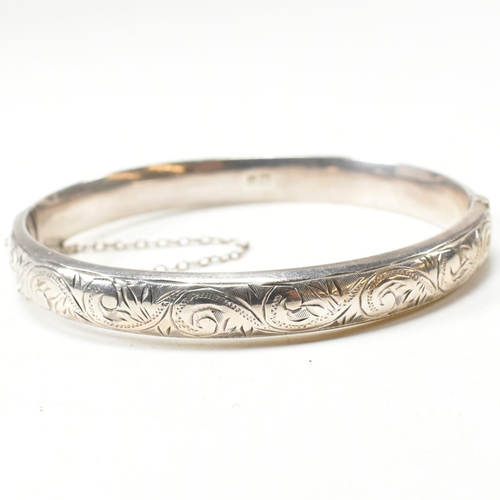 272 - A hallmarked silver hinged bangle together with a hallmarked marcasite brooch pin. The lot to includ... 