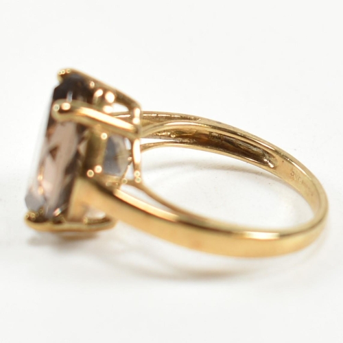 274 - A hallmarked 9ct gold and smoky quartz ring. The ring having a single four claw set wide marquise cu... 