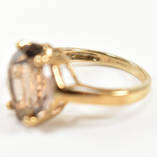 274 - A hallmarked 9ct gold and smoky quartz ring. The ring having a single four claw set wide marquise cu... 